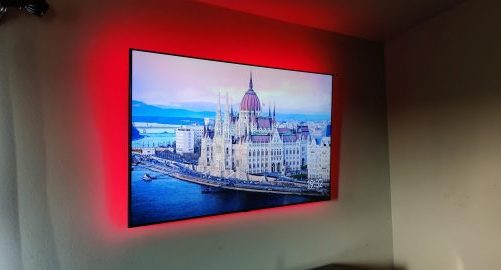 tv mounted on wall with rgb lights